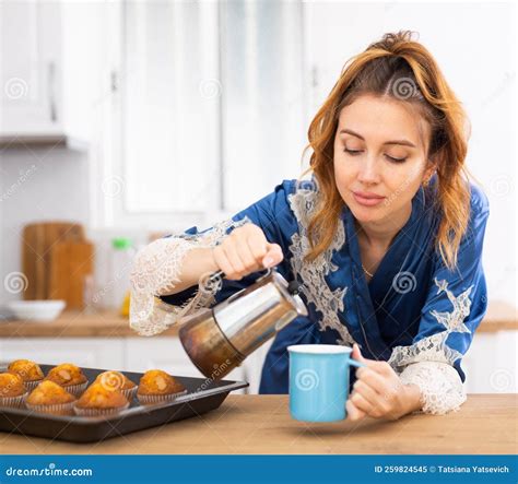 Upset Just Woken Up Woman In Blue Peignoir Preparing Coffee In Kitchen