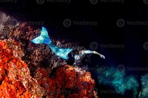 Mermaid Swimming Underwater In The Deep Blue Sea 12192365 Stock Photo