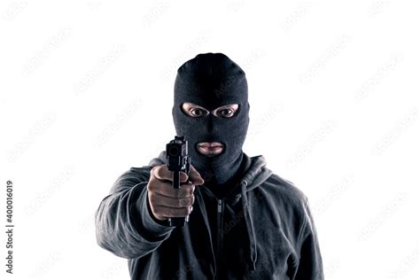 Criminal Wearing Black Balaclava And Hoodie With A Gun Isolated On