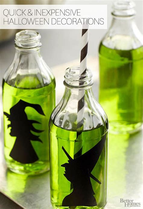Two Green Bottles With Halloween Decorations In Them And The Words