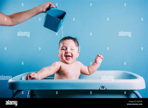 Happy Laughing Baby Taking A Bath Smiling Kid In Bathroom With Blue