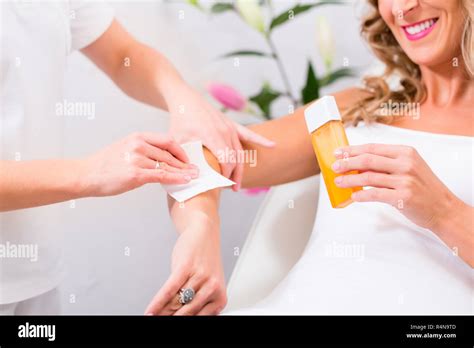 Woman at waxing hair removal in beauty parlor Stock Photo - Alamy
