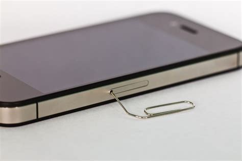 This question has a relatively simple answer so you should be able to resolve your sim card issue. How to Get a SIM Card Out of the iPhone 4 (with Pictures) | eHow
