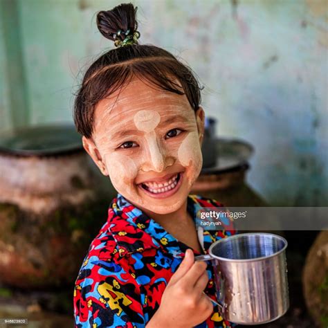Little Burmese Girl Drinking Water In Village Near Bagan