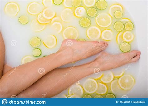 Unrecognizable Woman Takes A Milk Bath With Lemons And Limes Citrus