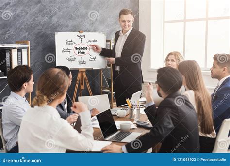 Businessman Presenting Business Plan To His Colleagues Stock Image