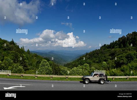 Jeep Driving Past View Of The Great Smoky Mountains Below Newfound Gap