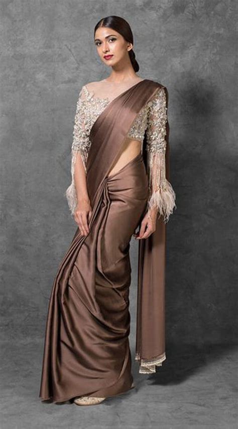 To make the blouse more attractive, play with captivating buttons and necks. Brown Satin and Net Designer Blouse Saree WJ96030