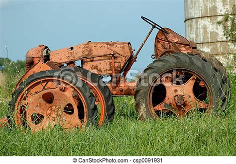 Vintage Farm Tractor A Rusty Old Antique Tractor Stands By The Silo Of