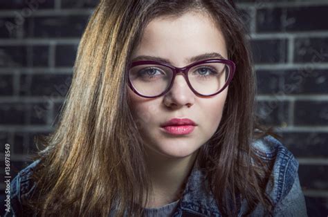 Portrait Of Beautiful Brunette Teen Girl Wearing Glasses Buy This