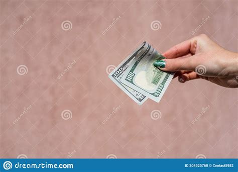 hand holding showing dollars money and giving or receiving money like tips salary 100 usd