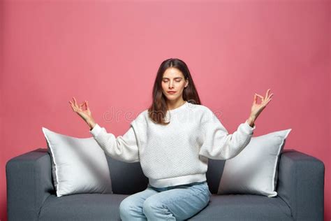 Calm Young Woman With Eyes Closed Do Mudra Om Gesture Meditating Breathing Sitting On Sofa