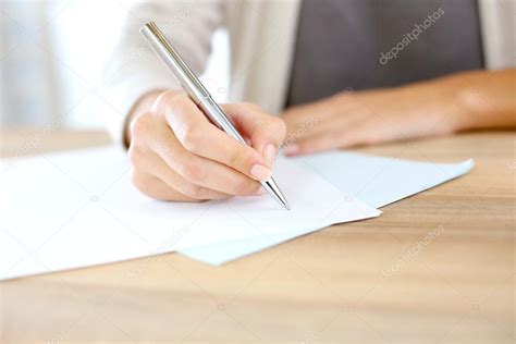 Womans Hand Writing On Paper — Stock Photo © Goodluz 35307069