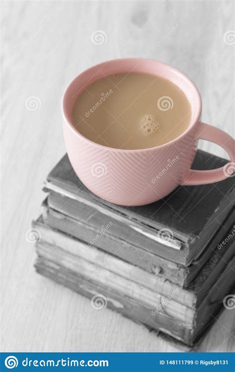 Cup Of Tea In A Pink Cup On A Stack Of Old Antique Books With Selective