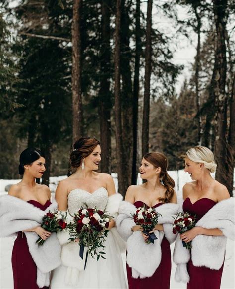 Three Bridesmaids In Red Dresses And Fur Stoles Smile At Each Other