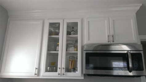 One solution is to make the shorter cabinet 12 in depth and the diagonal corner wall cabinet 15 deep. glass cabinet, white cabinets with crown molding | Our Kitchen | Pinterest | Crown moldings ...
