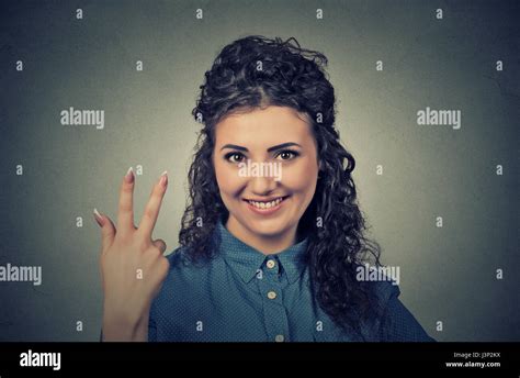 Closeup Portrait Of Young Pretty Woman Giving A Three Fingers Sign