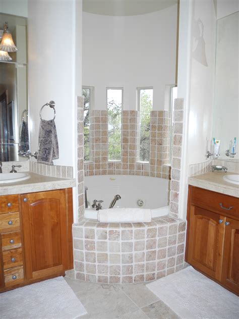A deep soaking tub is wonderful for warming up after skiing, soothing sore muscles and relaxing. spa-round-jetted-soaking-tub-accented-travertine-tile ...
