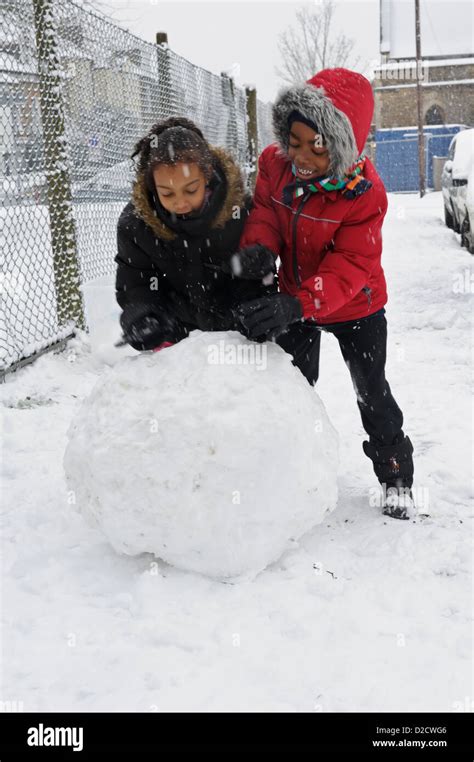 Children Rolling A Big Snowball United Kingdom Stock Photo Alamy
