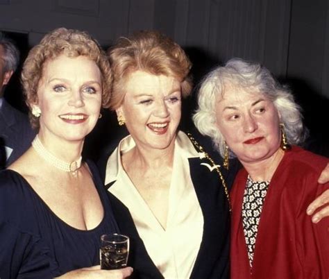 Three Women Standing Next To Each Other Holding Wine Glasses