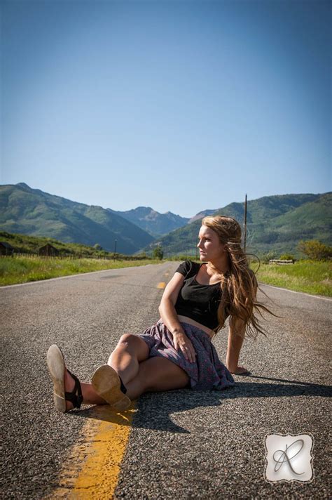 Creative Outdoor Senior Pictures Sitting In The Road With Mountains In