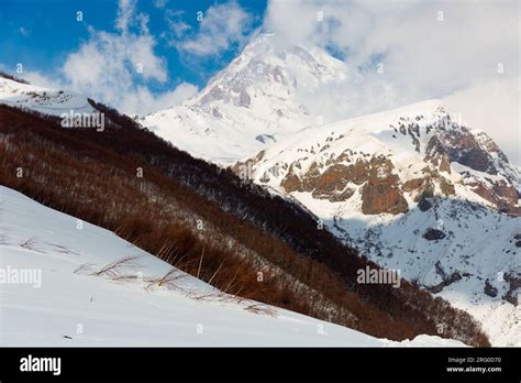 Mountain Landscape Of Snow Capped Caucasus Range With Kazbek Peak Stock