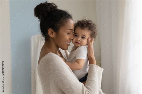 Happy Young African American Mom Hold In Hands Hug Cute Little Ethnic
