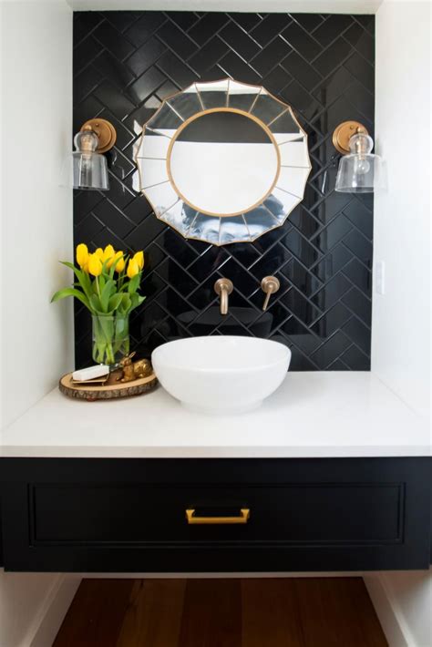 Powder Room Featuring A Black Tile Wall Art Deco Mirror And White Bowl