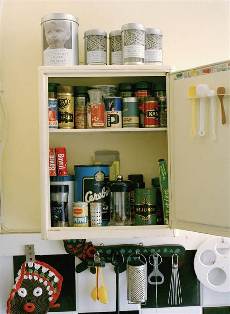 You can either nest them together with the lids removed, or you can store them with the lids on, lined up next to each other. Organize your Kitchen Cabinets