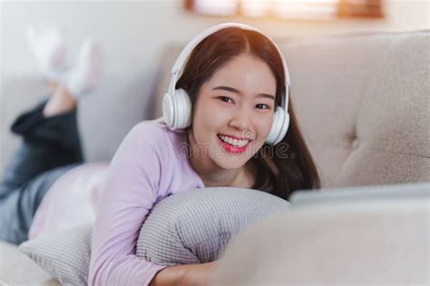 Attractive Asian Woman Resting Comfortable Living Room And Using Mobile