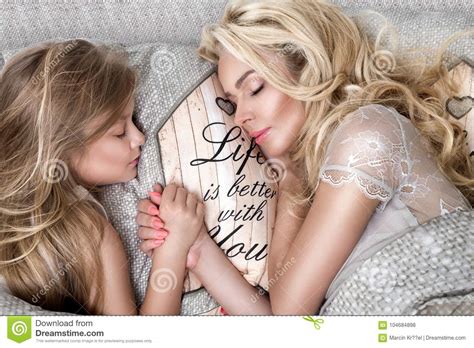 Portrait Of The Beautiful Blonde Woman Mother And Daughter On The
