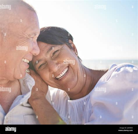 Affectionate Mature Mixed Race Couple Sharing An Intimate Moment On The