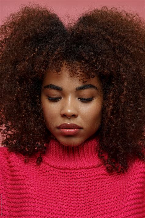 Portrait Of A Young African American Afro Woman In Pink Studio With
