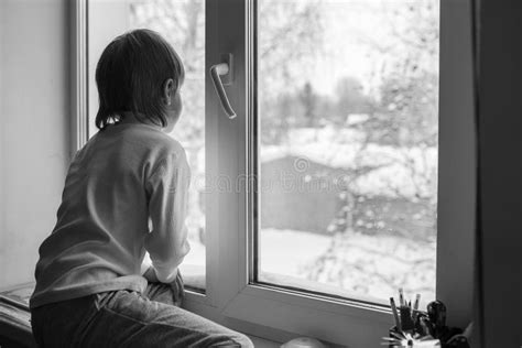 Boy Looks Out The Window On A Winter Day Stock Image Image Of Glass