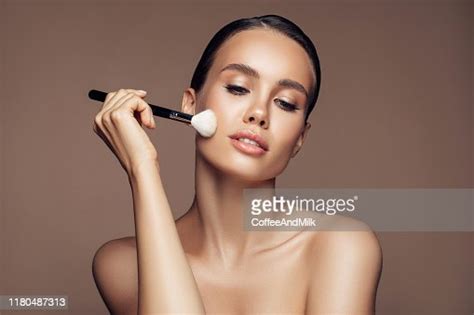 Beautiful Young Woman Applying Foundation Powder High Res Stock Photo