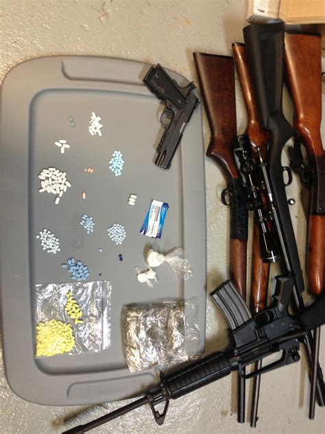 officers seize drugs guns and cash in raids at home and bar
