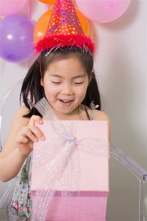 Little Girl Opening T Box At Her Birthday Party Stock Photo Image