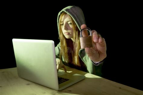 Young Attractive Teen Woman Wearing Hood On Hacking Laptop Computer