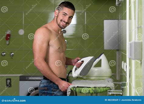 Naked Man Ironing Clothes In A Utility Room Imagen De Archivo Imagen