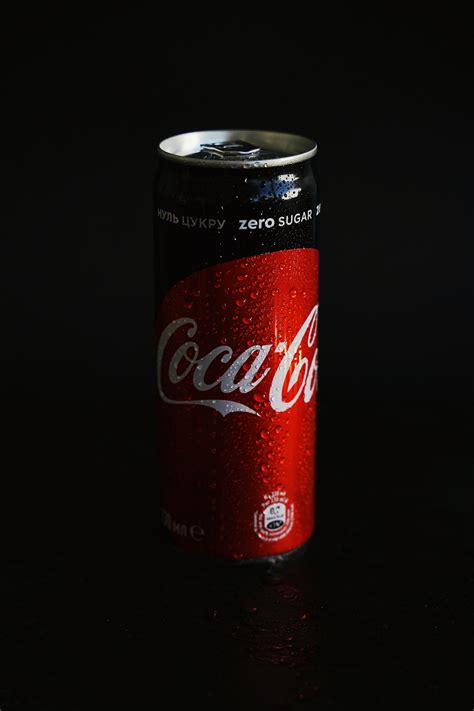 Coca Cola Can On Black Surface · Free Stock Photo