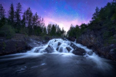 Starry Sky Over Waterfall In Norway