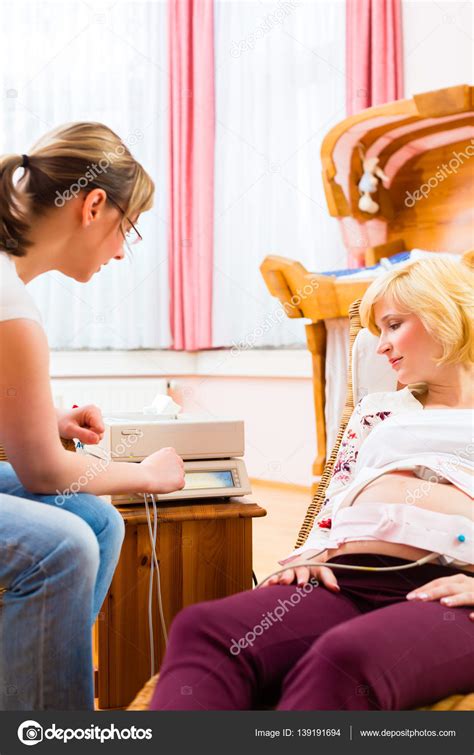 Midwife Seeing Mother For Pregnancy Examination Stock Photo By Kzenon