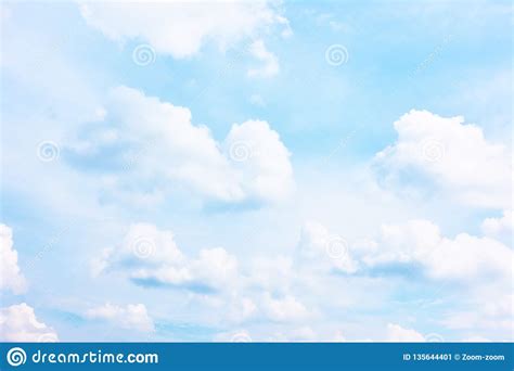 Bright Pastel Blue Sky With White Clouds Stock Image