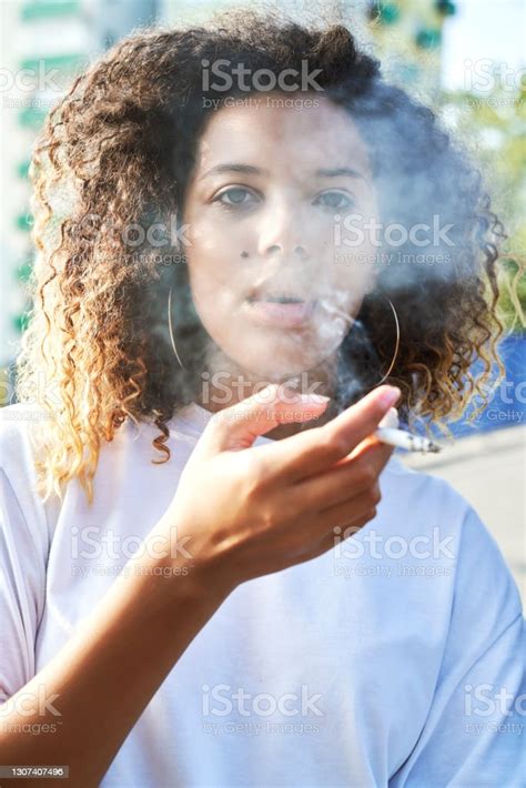 Portrait Of Young Woman Smoking Cigarette Stock Photo Download Image