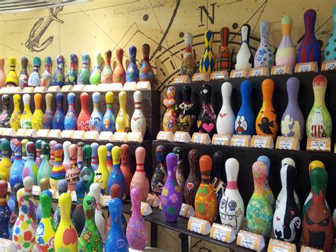 There Are Many Different Colored Bowling Pins On The Shelves In This