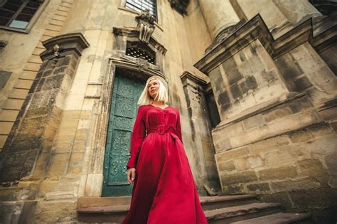 Premium Photo A Girl In A Red Dress Walks Near The Dominican Cathedral In The City Of Lviv