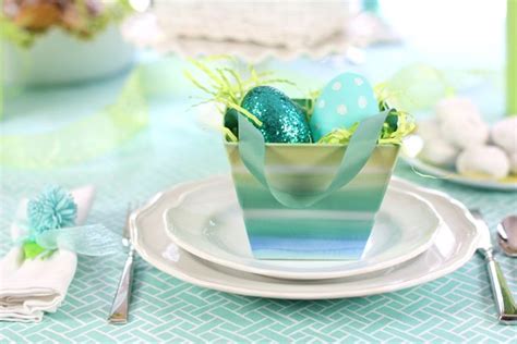An Easter Table Setting With Blue And Green Eggs