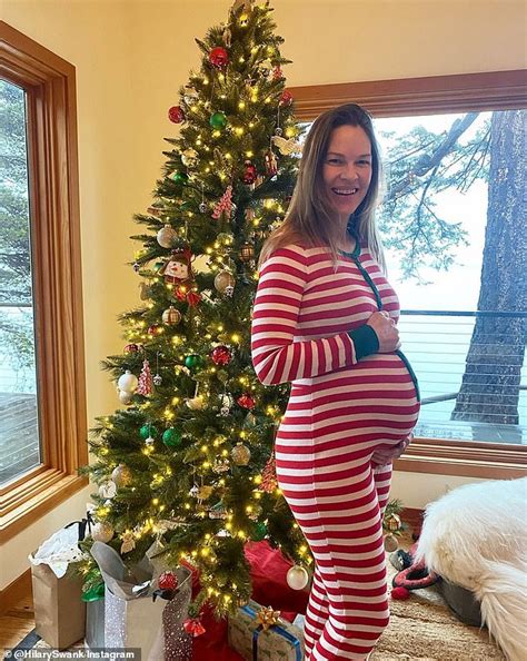 Hilary Swank Looks Festive In A Christmas Onesie As She Cradles Her Growing Miracle Baby Bump