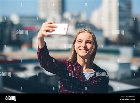 pretty woman taking a selfie beautiful girl walking on the streets and photographing some