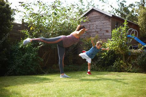 Mother And Son Exercising Standing In Yoga Position Stock Image F Science Photo